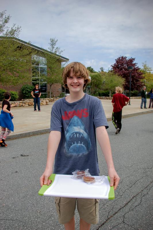 Chris Knight, a seventh grader at Old Rochester Regional Junior High School, helps sell baked goods at his friend's mitzvah project. BY SARA LAFRANCE